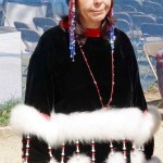 Woman wearing beaded hat and fur trim.