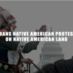 Native American man protesting in front of the Capitol.