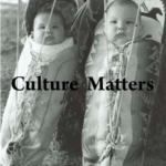 Two babies in traditional Native American cradles.