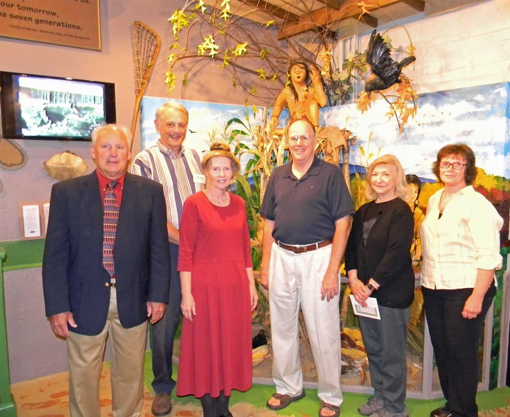 Group of people standing in a museum.